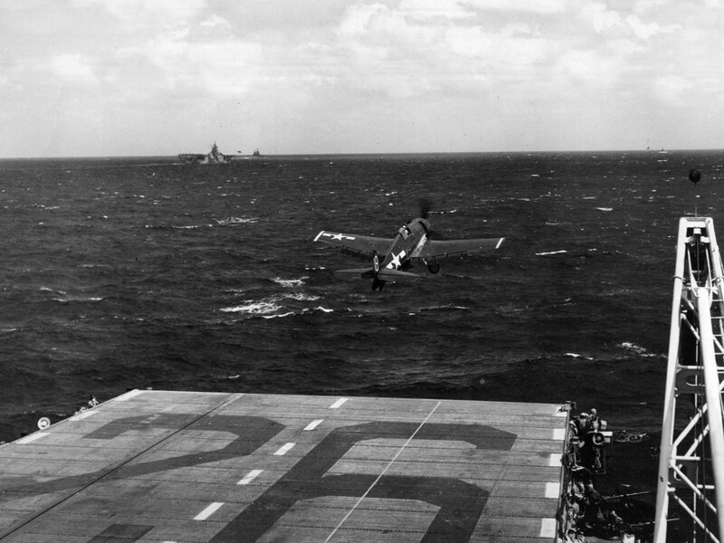 USS Monterey (CVL-26) - N613K.jpg :: USS Monterey (CVL-26), Light Aircraft Carrier, WW II - US NAVY PHOTO: An open-canopied F6F-5 Hellcat of VF-28 launches as part of USS Monterey's strikes on Okinawa on 10 Oct 1944, with USS Hornet (CV-12) in the distance. Monterey launched 32 CAP fighters and 28 strike sorties against the island and ships in the surrounding area as part of Task Force 38's pre-invasion support of the landings on Leyte in the Philippines a week later.