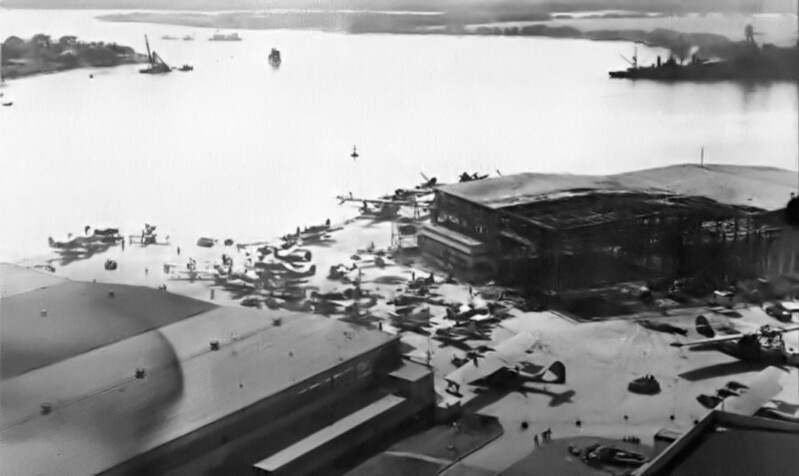 USS Nevada (BB-36) - N3061J.jpg :: USS Nevada (BB-36), Battleship, WW II - US NAVY PHOTO: This photo is looking down the channel at Pearl Harbor on 8 Dec 1941. The USS Nevada (BB-36) is visible at the far right of the photo, aground at Waipio Point being assisted by salvage craft. After first running aground at Hospital Point, to the left, the ship was moved by tugs to her present location to avoid bottle-necking the channel for ship traffic.