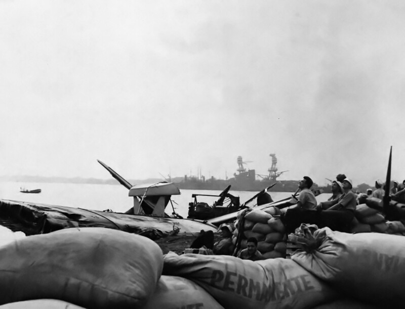 USS Nevada (BB-36) - N3061K.jpg :: USS Nevada (BB-36), Battleship, WW II - US NAVY PHOTO: Sandbagged .30 caliber machine gun emplacement with gun crew on alert, at the seaplane base near Ford Island's southern tip, soon after the Japanese attack. Note, the beached battleship USS Nevada (BB-36) beyond. Sandbags are marked \