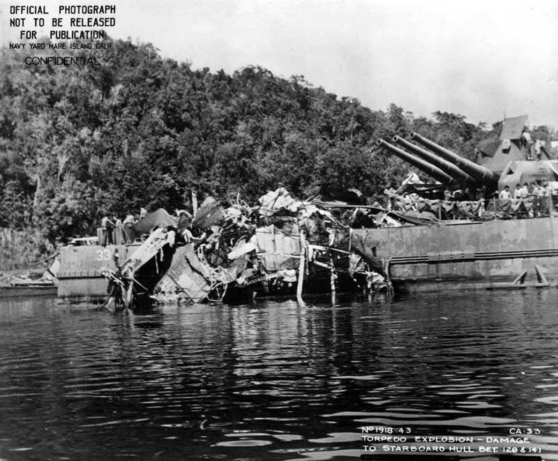 USS Portland (CA-33) - N1743M.jpg :: USS Portland (CA-33), Heavy Cruiser, WW II - US NAVY PHOTO: Starboard quarter view of the USS Portland (CA-33) while anchored at Tulagi. The damage visible was sustained on 13 Nov 1942. USS Portland (CA-33) took a torpedo hit at 0158 on the starboard quarter, which blew off both inboard propellers, jammed the rudder five degrees right, and jammed number three turret in train and elevation.