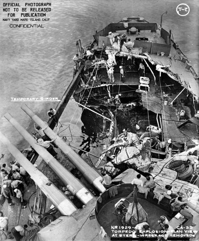 USS Portland (CA-33) - N1744C.jpg :: USS Portland (CA-33), Heavy Cruiser, WW II - US NAVY PHOTO: Overhead view of the USS Portland (CA-33) fantail while anchored at Tulagi. The damage visible was sustained on 13 Nov 1942.  USS Portland (CA-33) took a torpedo hit at 0158 on the starboard quarter, which blew off both inboard propellers, jammed the rudder five degrees right, and jammed number three turret in train and elevation. Here you can see the damaged area with the debris removed.