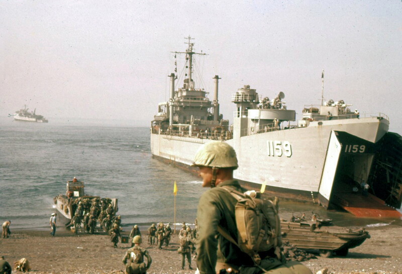 USS Tom Green County (LST-1159) - N26963B.jpg :: USS Tom Green County (LST-1159), Landing Ship, Tank, Vietnam War - US NAVY PHOTO: USS Tom Green County (LST-1159) beached at Okinawa in 1961. Note unidentified LSD in background, and Marines disembarking from LCVP.