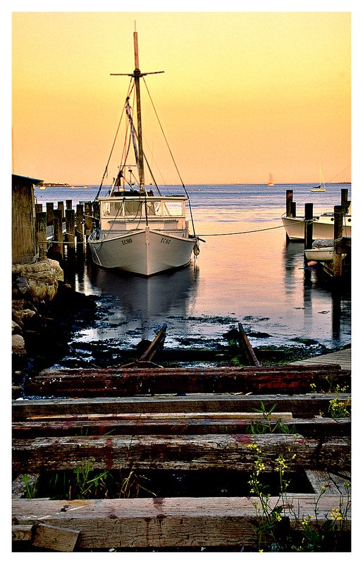 lobster boat-Noank.jpg :: Noank - A lobster boat with a marine rail in the foreground at dusk.