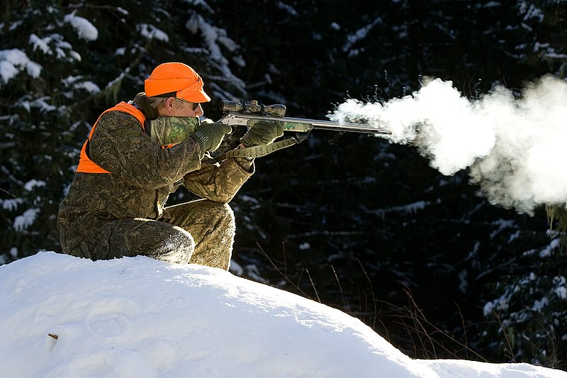 ©TC-Muzzleloader Hunter In Snow-D90008-00061.jpg :: Muzzleloader hunter in snow wearing Filson Wool Clothes in Advantage Timber Camoflage with florescent orange vest and hat shooting CVA Muzzleloader topped with Nikon Omega Muzzleloader scope