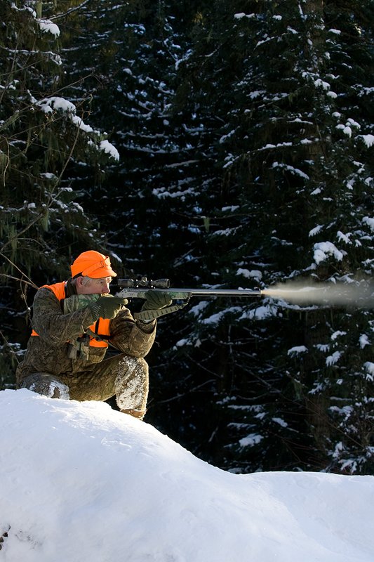 ©TC-Muzzleloader Hunter In Snow-D90008-00074.jpg :: Muzzleloader hunter in snow wearing Filson Wool Clothes in Advantage Timber Camoflage with florescent orange vest and hat shooting CVA Muzzleloader topped with Nikon Omega Muzzleloader scope