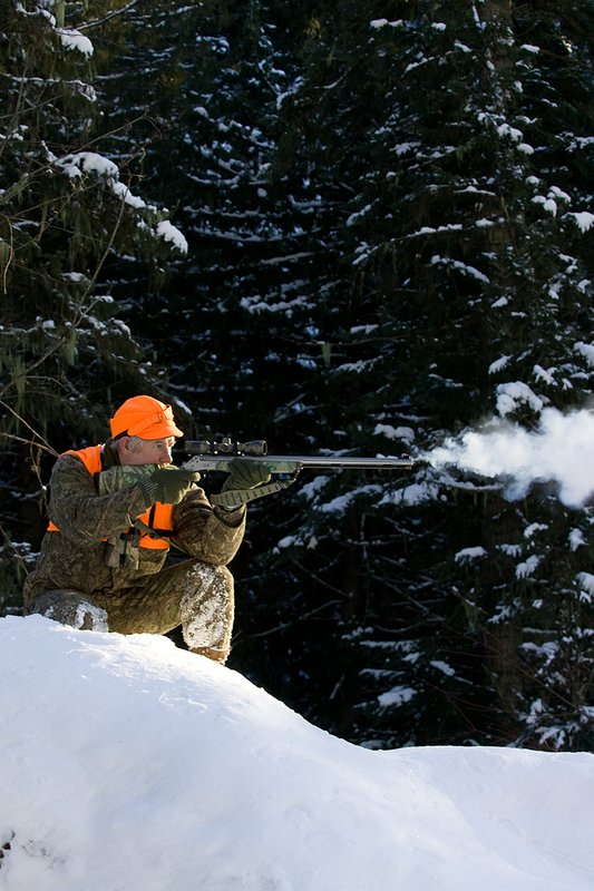 ©TC-Muzzleloader Hunter In Snow-D90008-00075.jpg :: Muzzleloader hunter in snow wearing Filson Wool Clothes in Advantage Timber Camoflage with florescent orange vest and hat shooting CVA Muzzleloader topped with Nikon Omega Muzzleloader scope