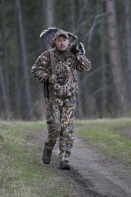 ©TC-Turkey Hunting-D90006-00396.jpg :: Turkey Hunter wearing Advantage Max 4HD Camo carrying Merriam Wild turkey out of the woods