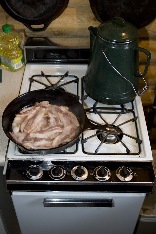 ©TC_Hunting Camps-D80003-103.jpg :: Elk Camp, cooking bacon and eggs on stove for breakfast in elk camp
