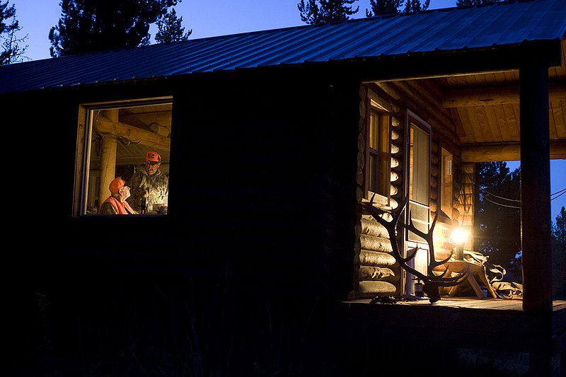 ©TC_Hunting Camps-D80003-137.jpg :: Elk Camp, cabin in woods, with elk rack on porch, panniers for carrying elk quarters,