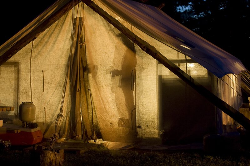 ©TC_Hunting Camps-D80003-243.jpg :: Hunters in wall tent, silhouetted in light from lantern
