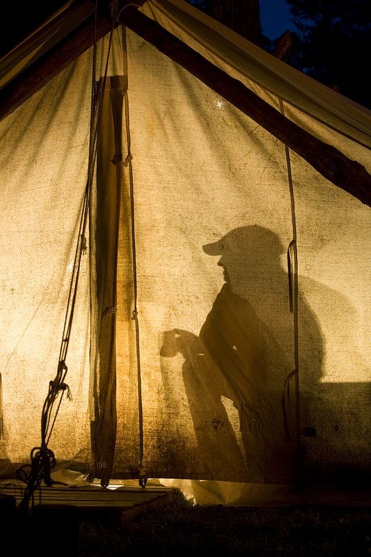 ©TC_Hunting Camps-D80003-246.jpg :: Hunters in wall tent, silhouetted in light from lantern