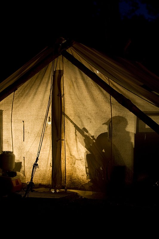 ©TC_Hunting Camps-D80003-250.jpg :: Hunters in wall tent, silhouetted in light from lantern