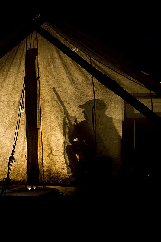 ©TC_Hunting Camps-D80003-261.jpg :: Hunters in wall tent, silhouetted in light from lantern