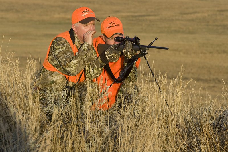 ©TC_Prairie Rifle Hunter-D89991-237.jpg :: Rifle hunter(s) on prairie, wearing Advantage Max-1HD camo, with a florescent orange vest, Bushnell Elite 3x9 Rifle sclope, Elite Binoculars