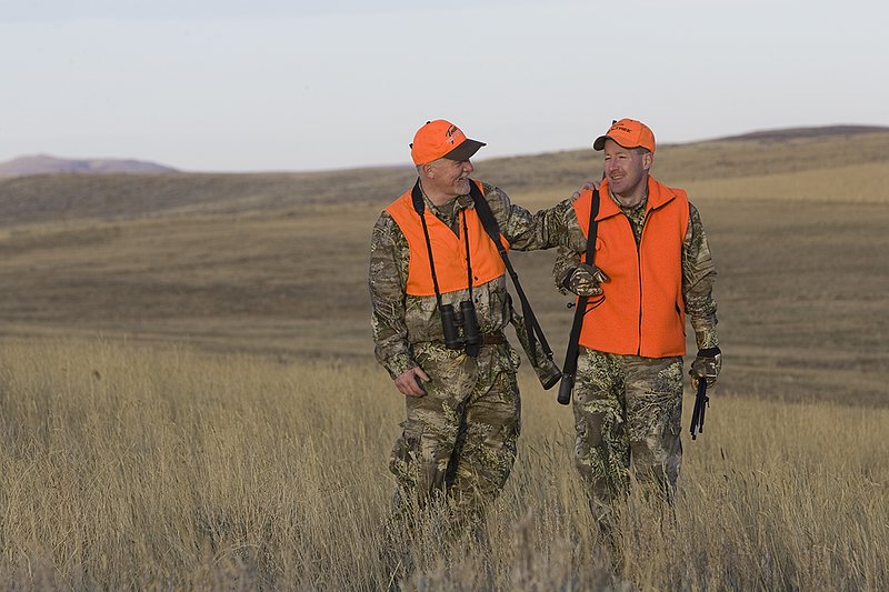 ©TC_Prairie Rifle Hunter-D89991-246.jpg :: Rifle hunter(s) on prairie, wearing Advantage Max-1HD camo, with a florescent orange vest, Bushnell Elite 3x9 Rifle sclope, Elite Binoculars