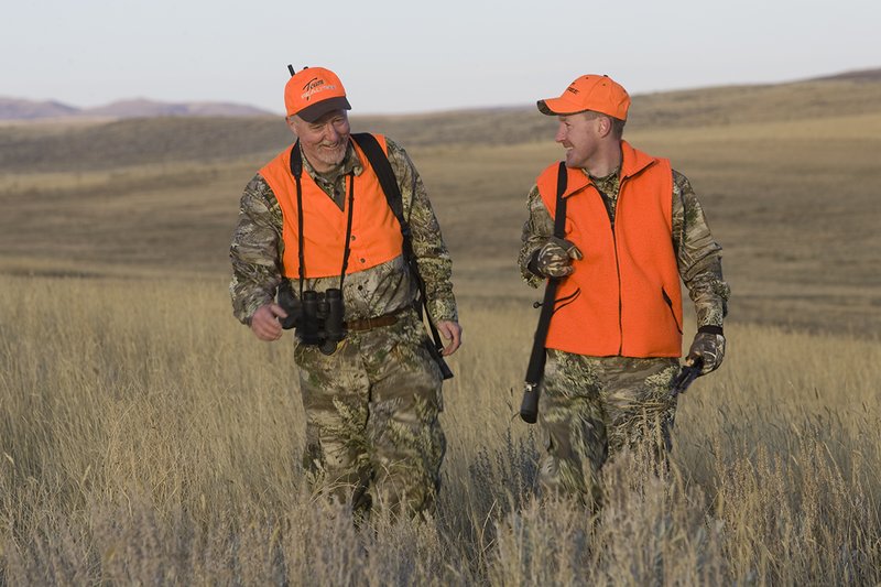©TC_Prairie Rifle Hunter-D89991-254.jpg :: Rifle hunter(s) on prairie, wearing Advantage Max-1HD camo, with a florescent orange vest, Bushnell Elite 3x9 Rifle sclope, Elite Binoculars
