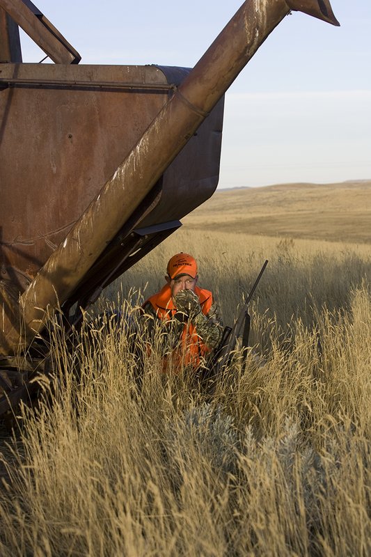 ©TC_Prairie Rifle Hunter-D89991-280.jpg :: Rifle hunter(s) on prairie, wearing Advantage Max-1HD camo, with a florescent orange vest, Bushnell Elite 3x9 Rifle sclope, Elite Binoculars