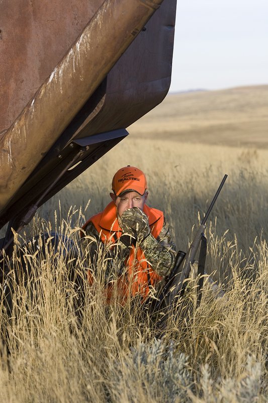 ©TC_Prairie Rifle Hunter-D89991-284.jpg :: Rifle hunter(s) on prairie, wearing Advantage Max-1HD camo, with a florescent orange vest, Bushnell Elite 3x9 Rifle sclope, Elite Binoculars