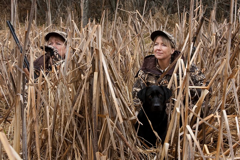 TC-Hunt-Women Waterfowl-D90081-00129.jpg :: Women Waterfowl Hunters in cattails, with black lab dog.