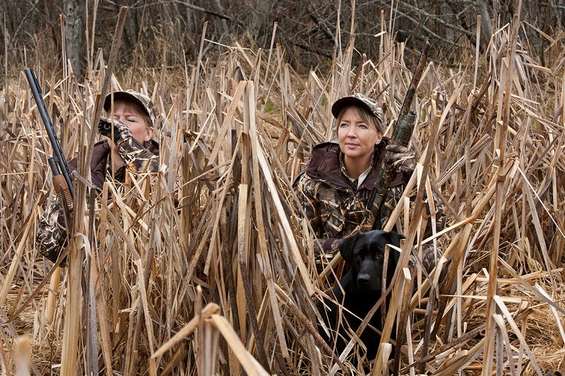 TC-Hunt-Women Waterfowl-D90081-00137.jpg :: Women Waterfowl Hunters in cattails, with black lab dog.