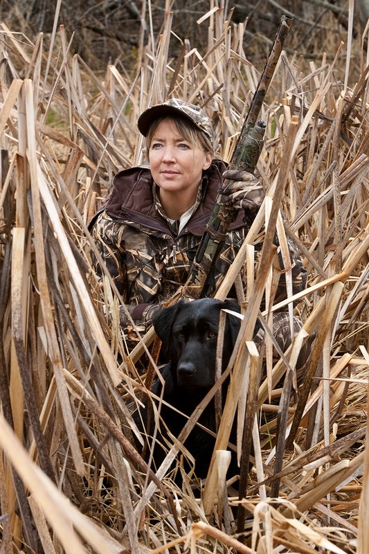 TC-Hunt-Women Waterfowl-D90081-00139.jpg :: Women Waterfowl Hunters in cattails, with black lab dog.