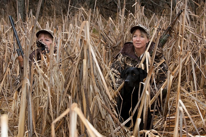 TC-Hunt-Women Waterfowl-D90081-00153.jpg :: Women Waterfowl Hunters in cattails, with black lab dog.