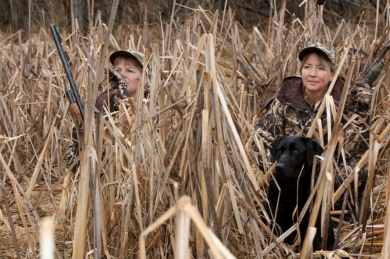 TC-Hunt-Women Waterfowl-D90081-00156.jpg :: Women Waterfowl Hunters in cattails, with black lab dog.