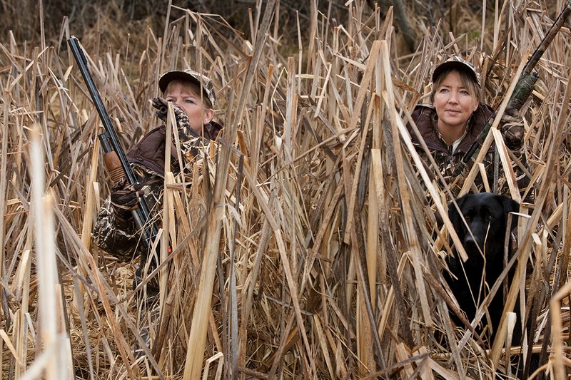 TC-Hunt-Women Waterfowl-D90081-00161.jpg :: Women Waterfowl Hunters in cattails, with black lab dog.