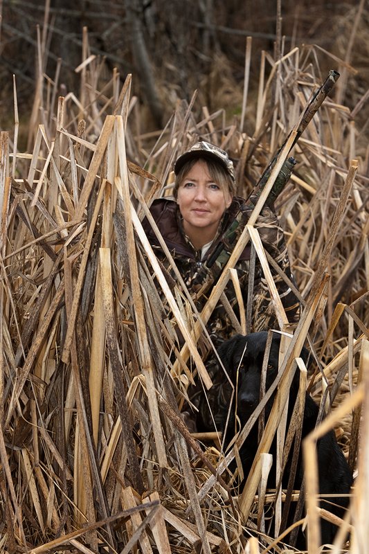 TC-Hunt-Women Waterfowl-D90081-00165.jpg :: Women Waterfowl Hunters in cattails, with black lab dog.
