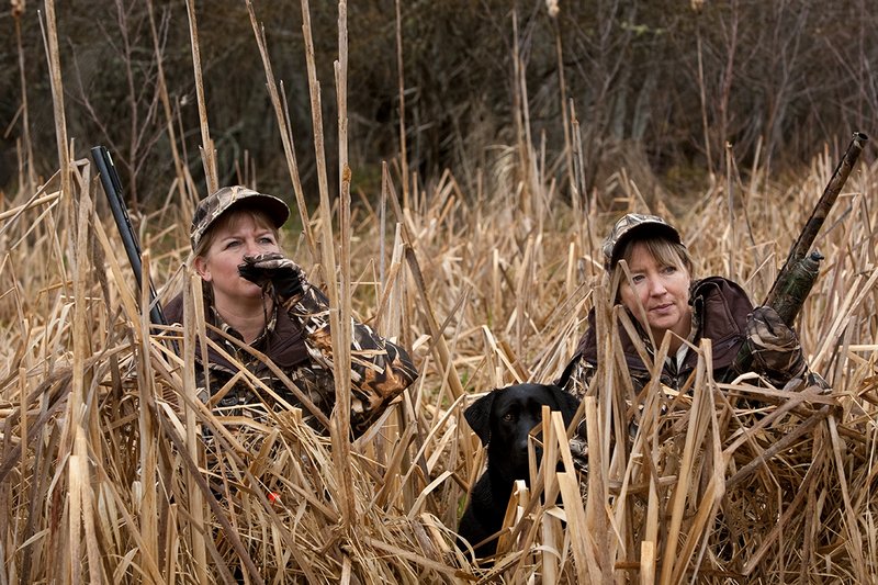 TC-Hunt-Women Waterfowl-D90081-00168.jpg :: Women Waterfowl Hunters in cattails, with black lab dog.