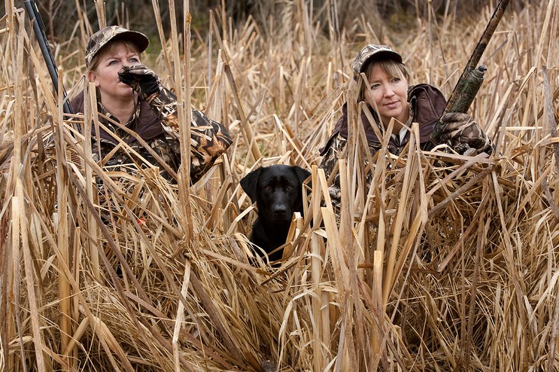 TC-Hunt-Women Waterfowl-D90081-00177.jpg :: Women Waterfowl Hunters in cattails, with black lab dog.