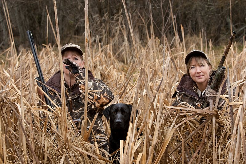 TC-Hunt-Women Waterfowl-D90081-00184.jpg :: Women Waterfowl Hunters in cattails, with black lab dog.