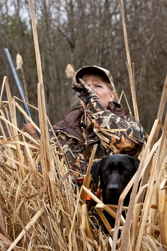 TC-Hunt-Women Waterfowl-D90081-00189.jpg :: Women Waterfowl Hunters in cattails, with black lab dog.