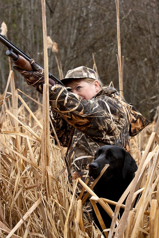 TC-Hunt-Women Waterfowl-D90081-00198.jpg :: Women Waterfowl Hunters in cattails, with black lab dog.