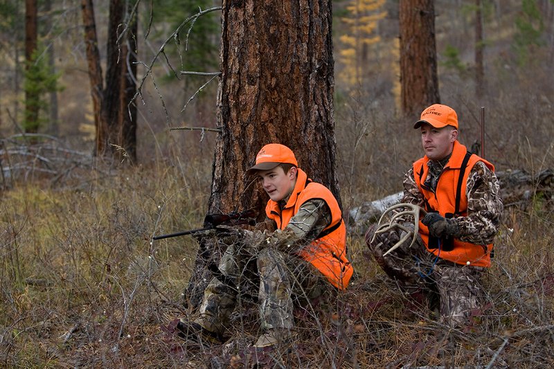 TC-Hunter Parent Child-D89995-00416.jpg :: Father (Jeff Christie) rattles antlers trying to attrack a whitetail buck for his son Jon while deer hunting on Jon's first deer hunt.