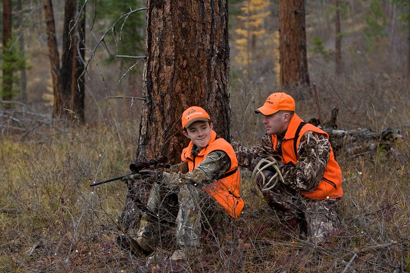 TC-Hunter Parent Child-D89995-00423.jpg :: Father (Jeff Christie) rattles antlers trying to attrack a whitetail buck for his son Jon while deer hunting on Jon's first deer hunt.