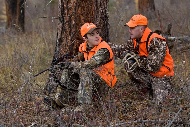 TC-Hunter Parent Child-D89995-00424.jpg :: Father (Jeff Christie) pauses from rattling for whitetail buck to advise his son Jon while deer hunting on Jon's first deer hunt.