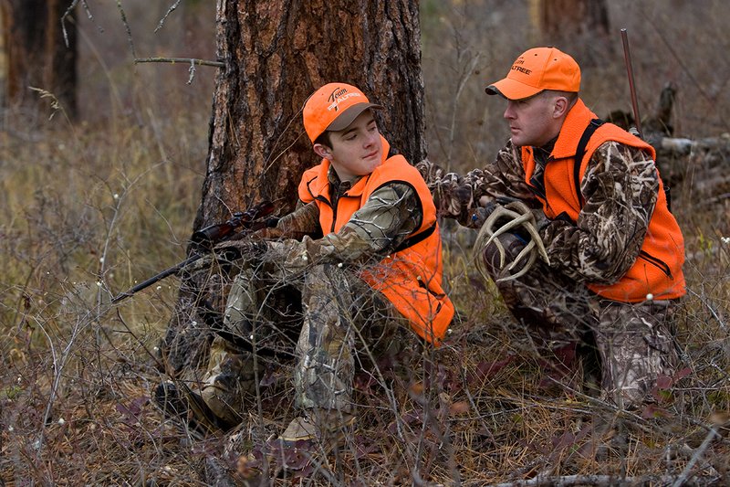 TC-Hunter Parent Child-D89995-00431.jpg :: Father (Jeff Christie) pauses from rattling for whitetail buck to advise his son Jon while deer hunting on Jon's first deer hunt.