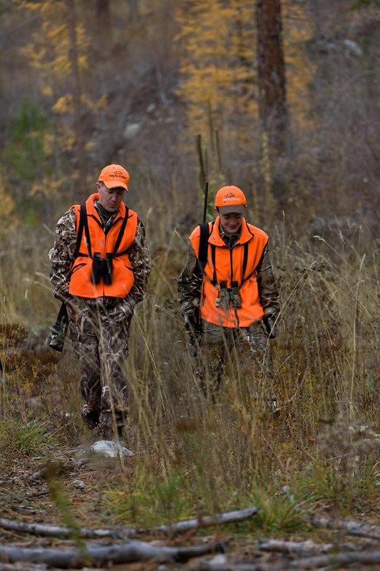 TC-Hunter Parent Child-D89995-00443.jpg :: Father (Jeff Christie) walks with his son Jon up an old two track while going to a deer stand on Jon's first deer hunt.
