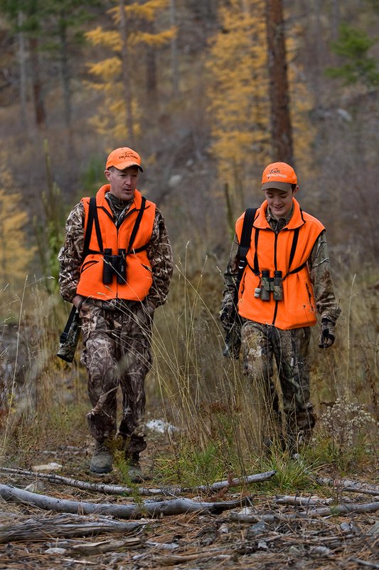 TC-Hunter Parent Child-D89995-00448.jpg :: Father (Jeff Christie) walks with his son Jon up an old two track while going to a deer stand on Jon's first deer hunt.