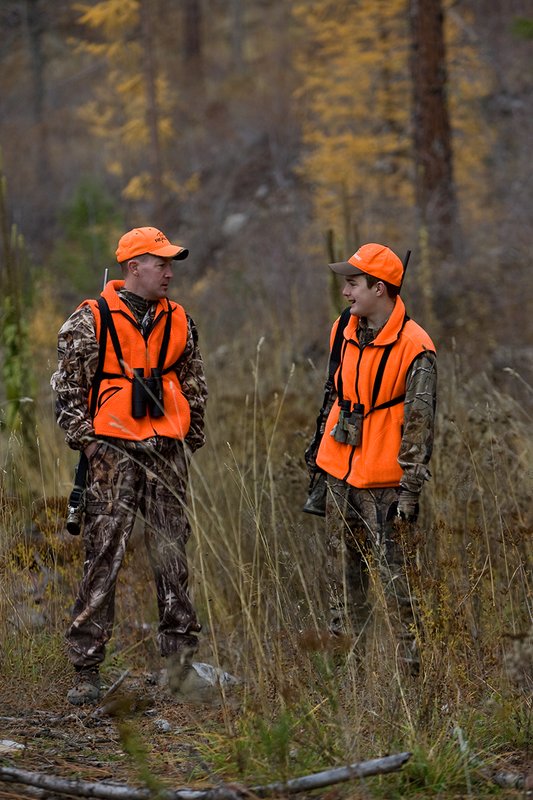 TC-Hunter Parent Child-D89995-00455.jpg :: Father (Jeff Christie) pauses to talk with his son Jon while standing in open timber while on Jon's first deer hunt.