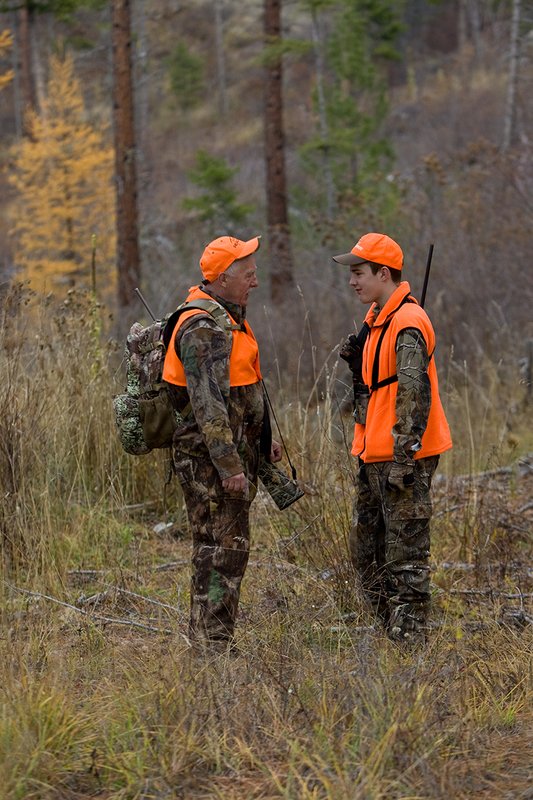 TC-Hunter Parent Child-D89995-00463.jpg :: Grandfather (Tim Christie) talks with his grandson Jon standing on old two track road while deer hunting on Jon's first deer hunt.