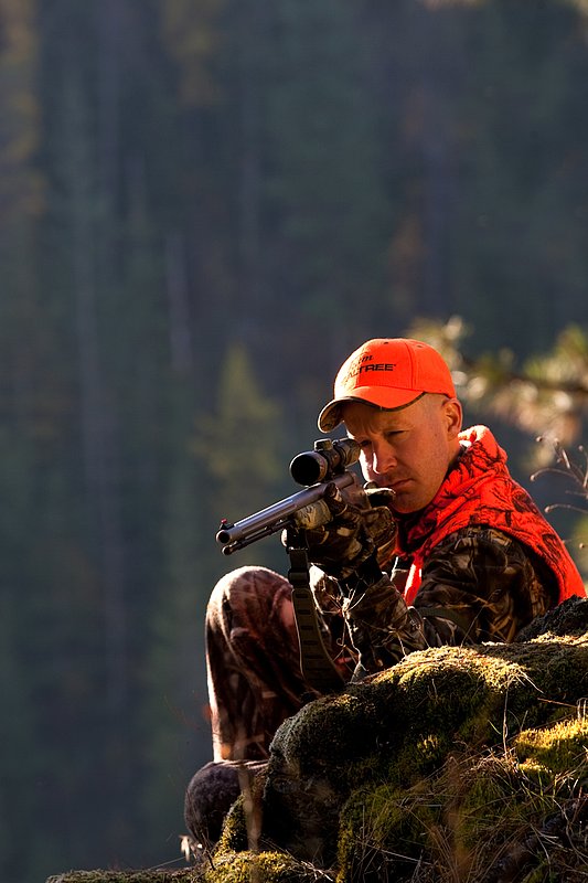 TC-Muzzleloader Hunters-D90008-00356.jpg :: Muzzleloader hunter wearing Advantage Max4-HD camo and Realtree Orange Vest shooting CVA Muzzleloader topped with Leuopold Omega Scope