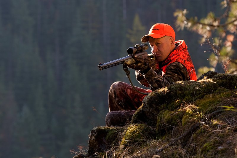 TC-Muzzleloader Hunters-D90008-00360.jpg :: Muzzleloader hunter wearing Advantage Max4-HD camo and Realtree Orange Vest shooting CVA Muzzleloader topped with Leuopold Omega Scope