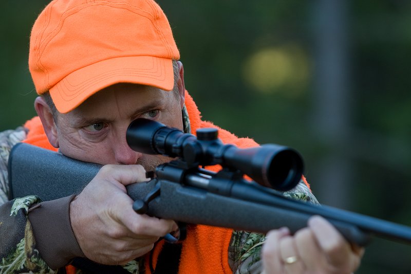 TC-Rifle Hunters-D90000-01259.jpg :: Rifle hunter wearing Realtree Max 1 camo and a florescent orange vest and hat aiming a custom Remington Model 700 topped with a Sightron 3x9 Big Sky Rifle scope