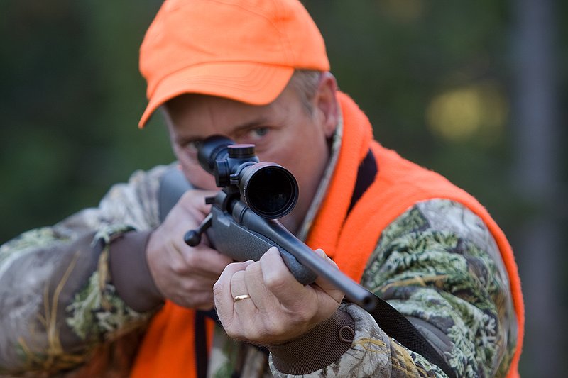 TC-Rifle Hunters-D90000-01263.jpg :: Rifle hunter wearing Realtree Max 1 camo and a florescent orange vest and hat aiming a custom Remington Model 700 topped with a Sightron 3x9 Big Sky Rifle scope