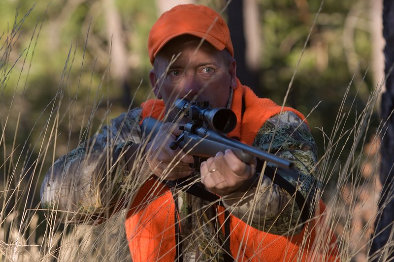 TC-Rifle Hunters-D90000-01275.jpg :: Rifle hunter wearing Realtree Max 1 camo and a florescent orange vest and hat aiming a custom Remington Model 700 topped with a Sightron 3x9 Big Sky Rifle scope
