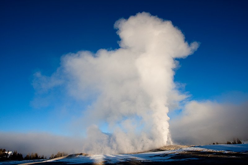 TC-Yellowstone winter-DYNP-W-00184.jpg :: Old Faitful Geyser erupting against blue sky and in fridgid cold air in winter in Yellowstone National Park