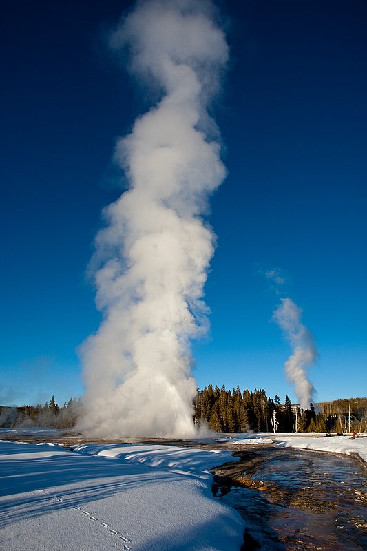 TC-Yellowstone winter-DYNP-W-00225.jpg :: Yellowstone National Park's Daisey Geyser errupting in frigid air in January against a blue sky in late afternoon light