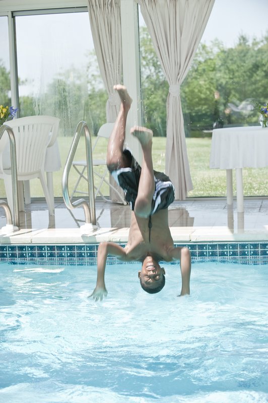 eathyn finishing a flip into the pool.jpg